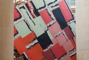 A component of Phyllida Barlow's installation at Tate Britain - a large diamond-shaped construction with wooden fretwork behind